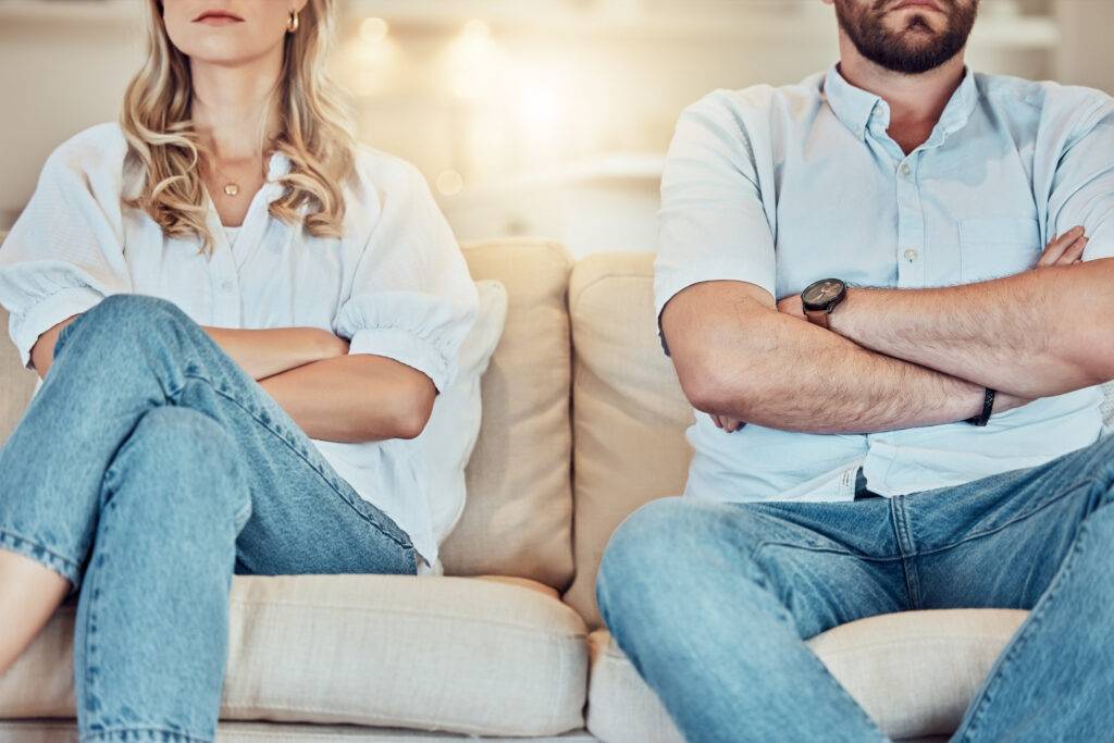 angry couple sitting on couch staring straight ahead