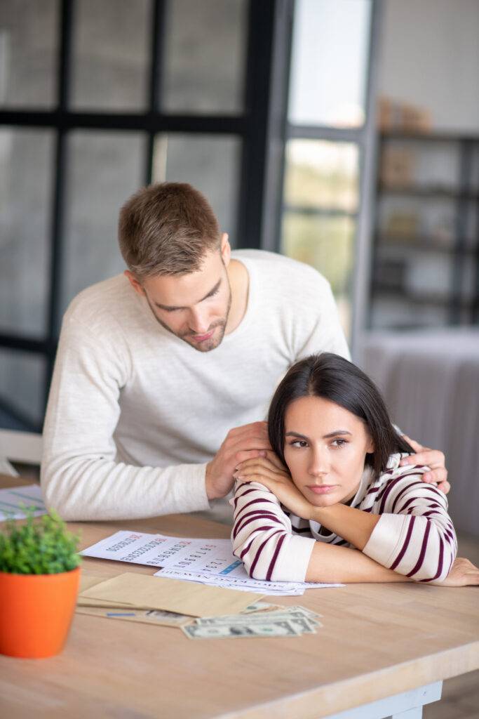 Husband supporting his wife after going over the family budget