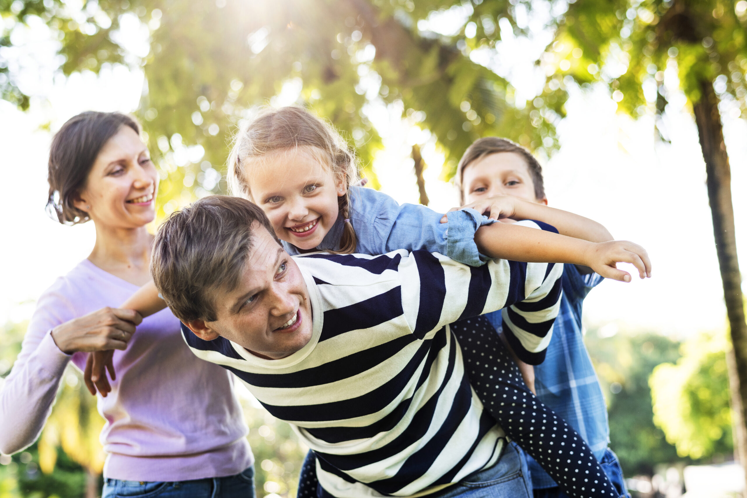 Family sharing a playful piggyback moment