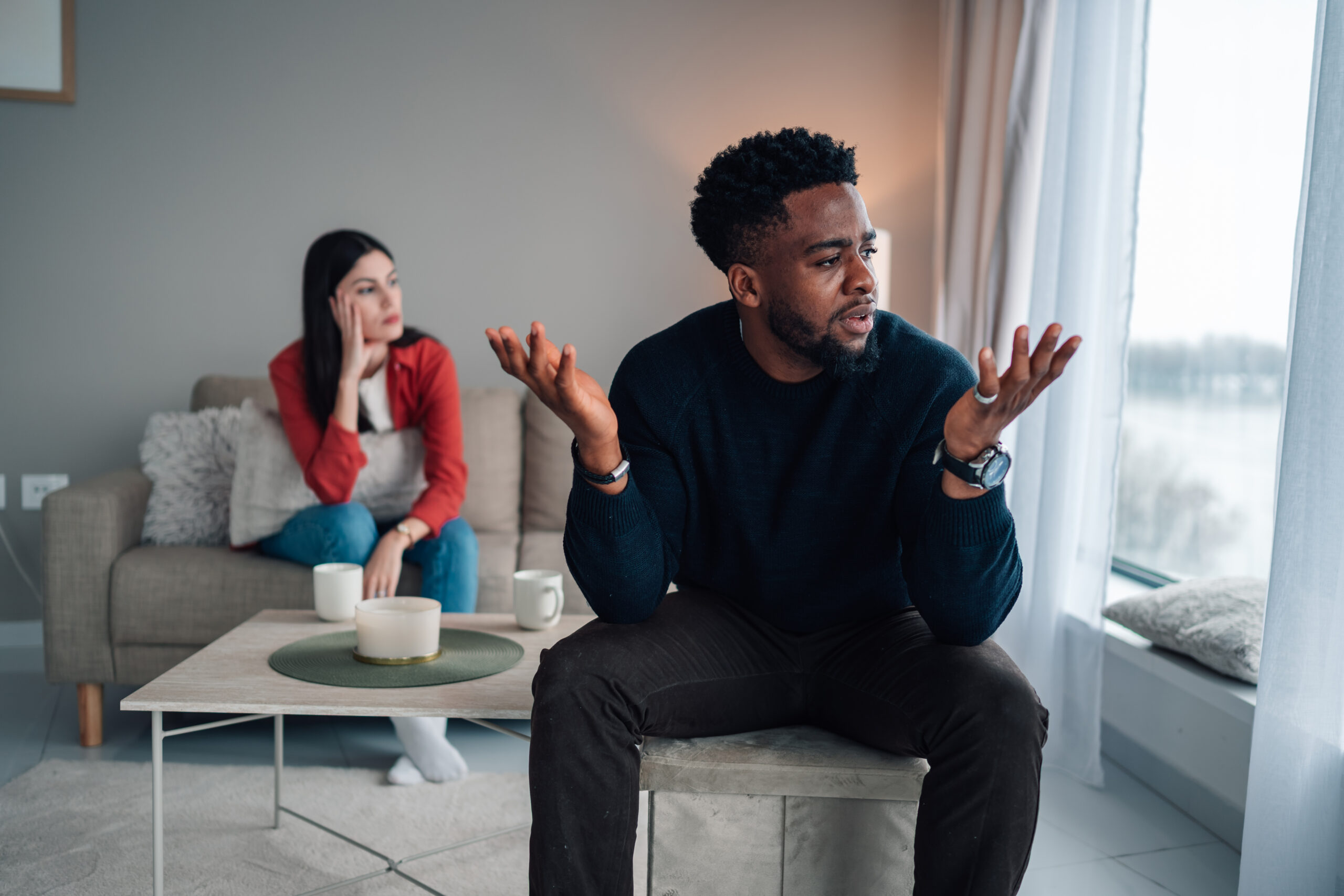 Frustrated couple in the middle of an argument at home