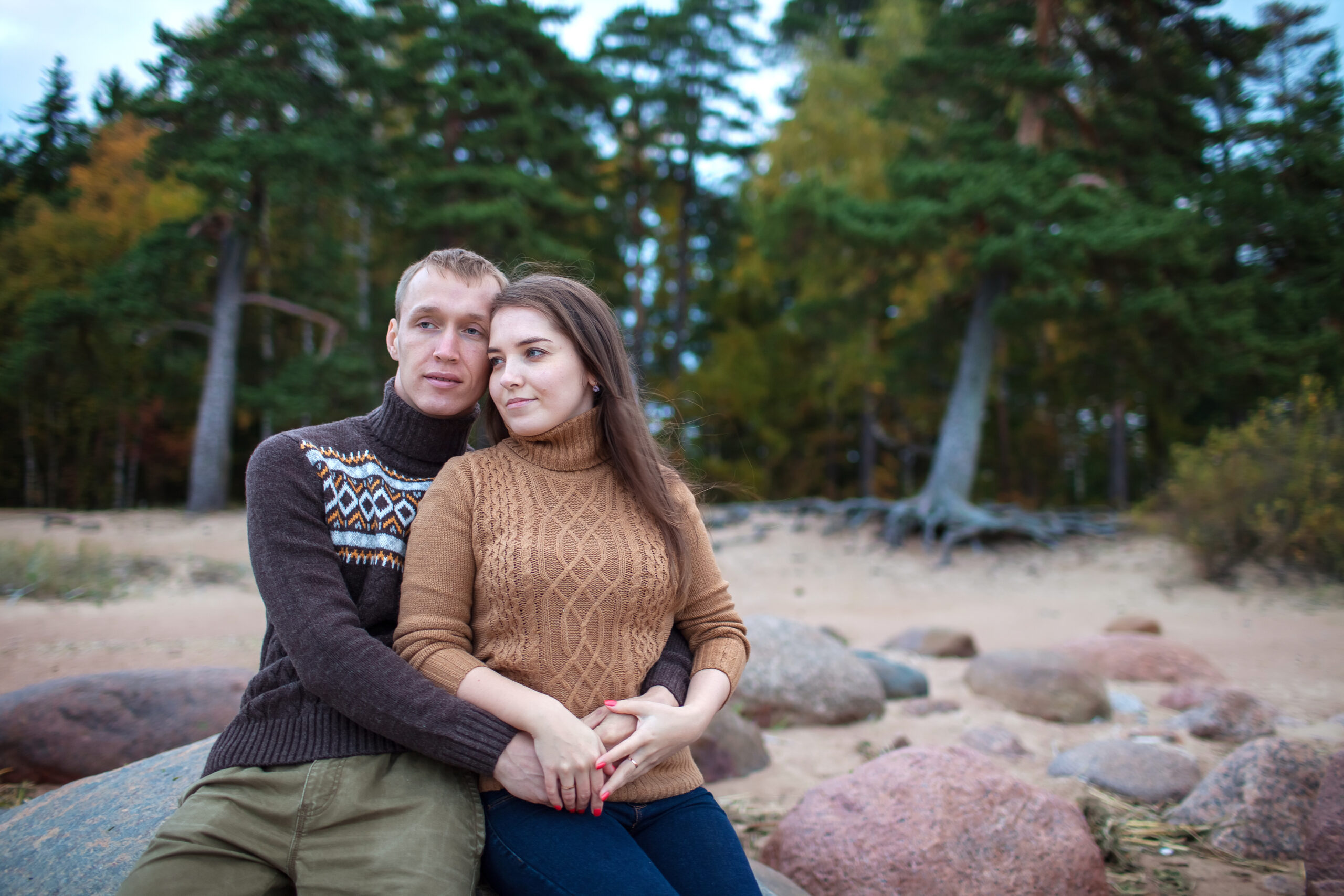 Couple embracing on a rocky shoreline